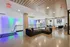 Luxurious modern living room with sleek furnishings, vibrant accent lighting, and expansive windows offering a bright, inviting ambiance.