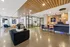 Modern and spacious lobby with sleek furniture, inviting lounge area, and a stylish conference room enclosed in glass walls.