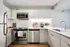 Modern kitchen at ReNew Waterside with sleek stainless steel appliances, elegant cabinetry, and a stylish countertop, perfect for gourmet cooking and entertaining.