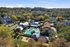 Lush aerial view of a beautiful apartment community featuring a sparkling pool, surrounded by vibrant autumn trees and modern buildings.