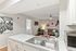 Inviting open-plan living area featuring a modern kitchen with sleek countertops, cozy seating, and stylish décor.