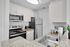 Modern kitchen with sleek granite countertops, stainless steel appliances, and chic cabinetry offering a stylish and functional cooking space.
