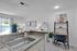 Bright and modern kitchen space featuring a sleek granite countertop, stylish sink, and a cozy workspace with artistic decor.