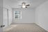 Bright bedroom featuring plush carpeting, large window with blinds, and modern ceiling fan for a cozy atmosphere.