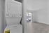 Modern apartment with in-unit laundry and bright living space featuring large windows and balcony access.