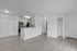 Modern apartment interior featuring a sleek kitchen with stainless steel appliances, spacious open-plan living area, and elegant wood flooring.