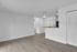 Bright and modern open-concept living area with sleek wood flooring and a stylish breakfast bar.