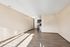 Bright and airy open-concept living space with modern kitchen featuring stainless steel appliances and sleek cabinetry.