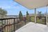 Modern balcony with stunning panoramic views overlooking lush greenery and a bustling neighborhood skyline.