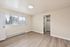 Bright, spacious bedroom with large window, modern flooring, and walk-in closet for elegant living.