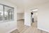 Bright and airy modern apartment featuring spacious living area with sleek wooden floors and a stylish kitchen.