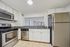 Modern kitchen with sleek stainless steel appliances, granite countertops, and ample cabinet space.