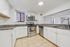Modern kitchen space with sleek stainless steel appliances, elegant granite countertops, and pristine white cabinetry for a stylish look.