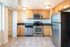 Modern kitchen with stainless steel appliances, granite countertops, and ample cabinet space.