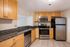 Chic kitchen showcasing modern stainless steel appliances, elegant granite countertops, and sleek wooden cabinetry for a stylish cooking space.
