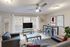 Modern living room with stylish furniture, large windows, and chic decor, perfect for relaxation and entertaining.