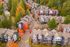 Charming aerial view of a picturesque neighborhood featuring vibrant autumn foliage, cozy townhouses, and tree-lined streets.