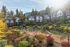 Charming townhouse complex nestled against a scenic mountain backdrop with lush landscaping and a well-maintained playground.