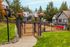 Charming community dog park with lush green surroundings and a cozy bench, perfect for pet-friendly living.