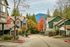 Charming residential neighborhood featuring colorful autumn trees and mountain views, highlighting picturesque modern homes.
