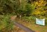 Inviting Tennant Trailhead Park entrance surrounded by lush greenery and vibrant autumn leaves, ideal for nature walks and outdoor adventures.