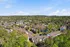 Townhomes at TSC Expansive aerial view of a vibrant apartment community nestled in lush greenery, showcasing modern buildings and serene surroundings.