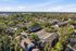 Townhomes at TSC Charming aerial view of a serene residential community nestled among lush greenery, showcasing spacious townhomes with ample parking.