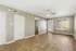 Townhomes at TSC Bright and spacious living room with elegant wood flooring, large window, and modern ceiling fan. Perfect for creating a cozy and inviting home atmosphere.