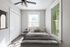 Bright and cozy bedroom with modern furnishings, large windows, and stylish ceiling fan, perfect for relaxation.