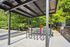 Modern covered bike rack area surrounded by lush greenery, offering convenience and style in a secure setting.