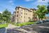 Charming multi-story apartment complex with attractive landscaping, ample parking, and a vibrant, sunny exterior.