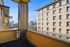 Charming balcony view showcasing a vibrant cityscape and historic architecture, perfect for a relaxed urban lifestyle.