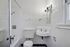 Charming vintage bathroom featuring elegant tile work, classic wall-mounted sink, and a cozy atmosphere.