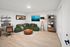Contemporary living space featuring a stylish green sectional, modern workspace with sleek desk, and elegant decor, perfect for comfort and productivity.