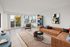 Bright and modern living room featuring a stylish brown sofa, elegant decor, and a sunlit balcony view.