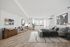 Elegant bedroom with a comfortable bed, stylish wooden flooring, modern decor, and ample natural light through large windows.