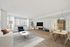 Bright and spacious living room with modern decor, featuring a cozy cream sofa, stylish blue armchair, and a sleek entertainment setup. Elegant dining area with natural wood table, all under soft lighting and a serene atmosphere.