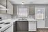 Bright, modern kitchen with sleek cabinetry, white countertops, and ample natural light.