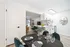 Modern open-concept kitchen and dining area featuring elegant decor and a comfortable living room with a scenic view.
