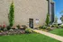 Inviting entrance to leasing office, surrounded by vibrant landscaping and lush green lawns.