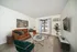 Chic living room with a cozy brown sofa, modern armchair, and stylish decor creating a warm ambiance.