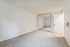 Bright, spacious room featuring plush carpeting and stylish mirrored closet doors.