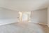 Bright and airy living room with plush carpeting and natural light creating an inviting ambiance.