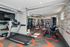Modern fitness center featuring state-of-the-art exercise equipment, mirrored walls, and vibrant decor.