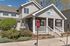 Charming apartment exterior with inviting front porch and lush landscaping, perfect for future residents seeking a welcoming community.
