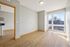 Bright and inviting room with sleek wood flooring and large windows, perfect for natural light enthusiasts.