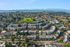Stunning aerial view of a vibrant residential community nestled amidst lush greenery and scenic water views, offering a perfect blend of nature and urban living.