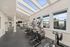 Bright and modern fitness center with sleek cardio machines and expansive skylight windows.