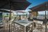 Chic rooftop terrace with modern seating, large umbrellas, and a sleek stainless-steel grill, perfect for entertaining with stunning views.