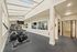 Bright and modern fitness center with state-of-the-art cardio equipment and skylight ceiling, offering a healthy lifestyle.